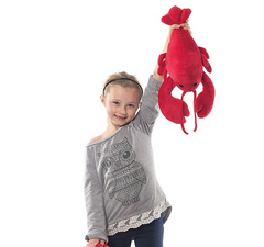 Young girl holding the Lobster Lobbie 31in plush toy, bright red with detailed claws and black eyes.