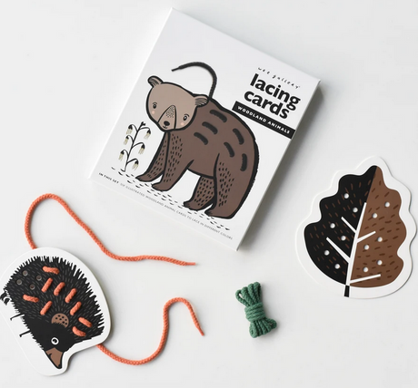 Woodland Lacing Cards featuring hand illustrated bear, hedgehog, and leaf shapes with lacing yarn for kids.