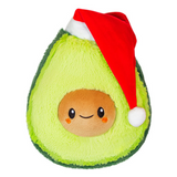 Santa Avocado Snackers plush toy wearing a red Santa hat, soft and weighted, perfect holiday gift.