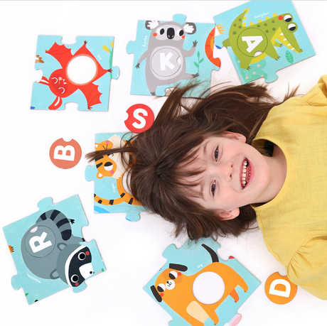 Child playing with colorful animal and letter pieces from the 50pc Suuper Alphabet Match Floor Puzzle educational set