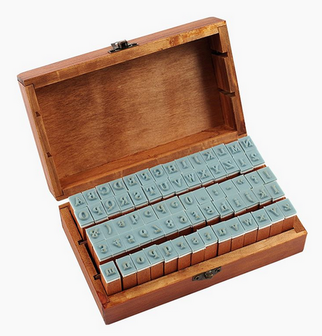 Letterpress Stamp Set featuring 70 vintage-style letter, number, and punctuation stamps in a rustic wooden box.