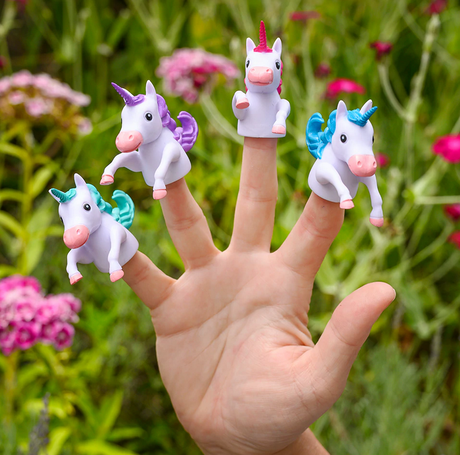 Finger Unicorn finger puppets in assorted colors on fingertips against a green garden background.