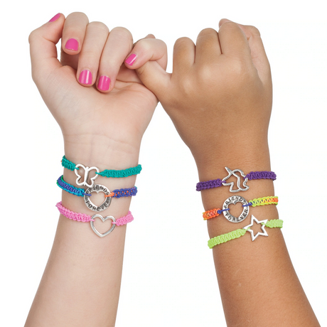 Hands wearing colorful DIY charm bracelets with silver charms linked by pinky fingers, Friends Forever Bracelets.