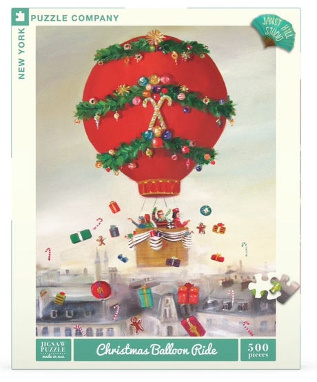 500pc Christmas Balloon Ride Puzzle showing a festive hot air balloon decorated with garlands dropping gifts over town.