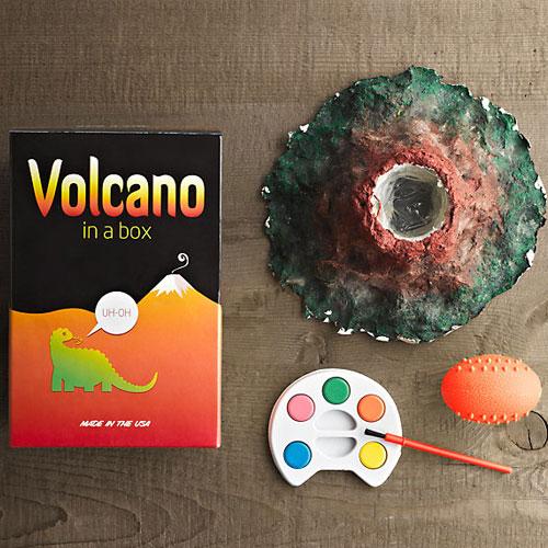 Volcano in a Box kit with papier-mâché volcano, paint palette, brush, and eruption materials for kids.