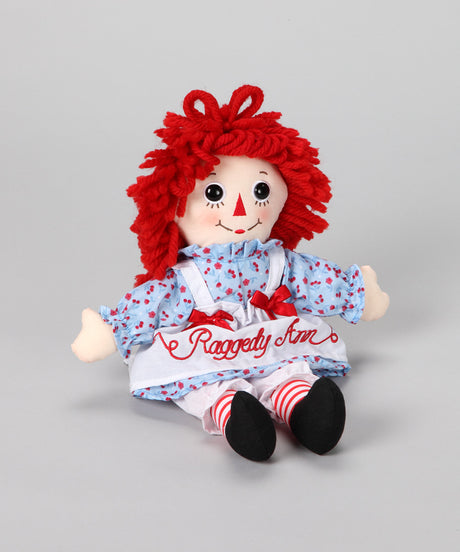 Raggedy Ann doll by Aurora with red yarn hair, vintage dress, candy-cane striped tights, and embroidered face.