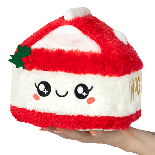 Eggnog Mini plush with red and white holiday colors, cute smiling face, and soft polyester fiber, held in hand.