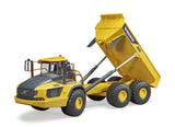 Volvo A60H Hauler with tipping bed raised, showcasing articulated steering and large balloon tires for off-road work.