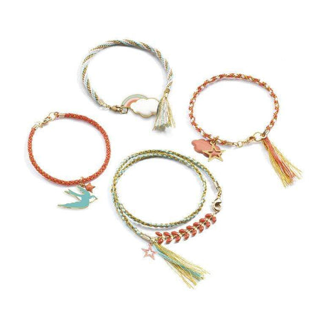 Celeste Beads Set featuring four unique, colorful handmade bracelets with charms and tassels on a white background.