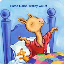Llama Llama Wakey Wake board book illustration of a llama stretching in bed with a colorful quilt.