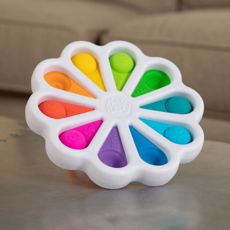 Dimpl Digits colorful silicone bubble toy with numbers and words embossed for tactile learning and fine motor skill development.