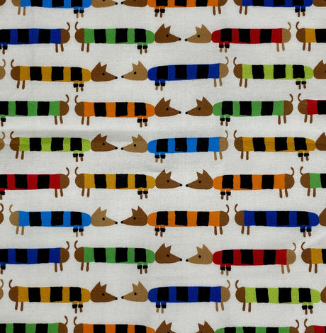 Baby Paper | Organic Dachshunds fabric featuring colorful striped dachshund pattern on a white background.