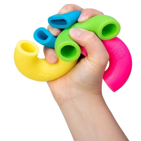 Hand squeezing colorful giant macaroni noodles toy in vibrant colors for stress relief NeeDoh Mac n Squeeze