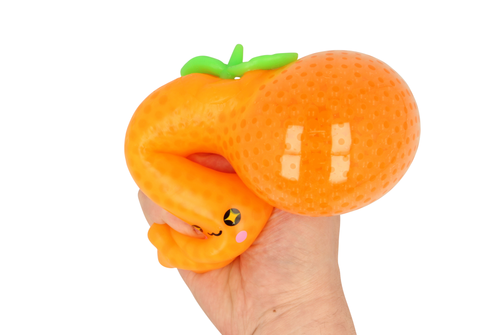 Hand squeezing bright orange Fruit CrushOs Orange toy, perfect for fidgeting and squishing fun.