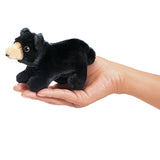 Black Bear Finger Puppet shown on a hand, soft plush toy perfect for imaginative forest play, 6 inches long.