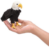 Eagle Finger Puppet shown on a hand, featuring black and white feathers and a yellow beak, perfect for imaginative play.
