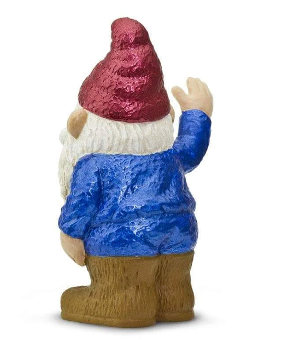 Gnorman the Gnome figurine wearing red hat, blue jacket, brown boots, and waving with white beard visible from the back.