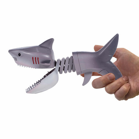 Shark vs Dino Chompers toy showing a gray shark with chomping jaws held in a hand, fun for kids ages 3 and up