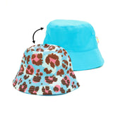 Bucket Hat Wild Child reversible kids hat with colorful leopard print and solid blue, durable and SPF50+ protection.