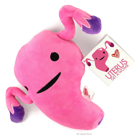 Pink fluffy plush toy shaped like a uterus with smiling face and educational hangtag for the product Uterus.