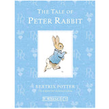 The Tale of Peter Rabbit book cover featuring illustrated rabbit in blue jacket on a light blue background.