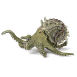 Kraken figure with dark sea green body, spiral shell with spines, rusted chain, and yellow eyes on white background.