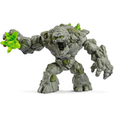 Eldrador Creatures | Stone Monster figure with rocky texture and glowing green crystal fist, fierce colossus pose.